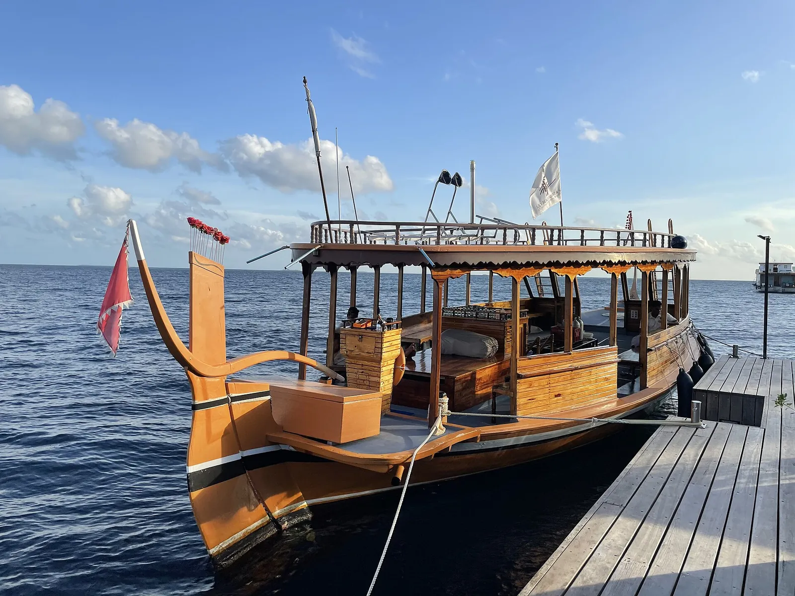 Traditional wooden Maldivian dhoni moored at an island jetty